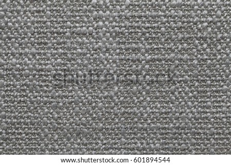 Gray knitted woolen background with a pattern of soft, fleecy cloth. Texture of textile closeup. Royalty-Free Stock Photo #601894544