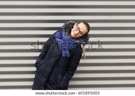 Beautiful girl on a striped wall background.