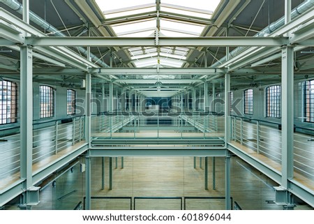 Modern industrial interior with roof windows, steel railings and balustrades