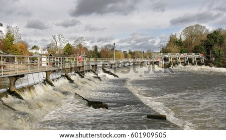 Swollen river Thames passing through a Weir and sluice at Maidenhead