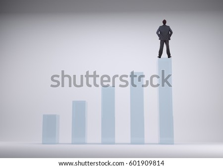 Digital composite of Businessman standing on a graph against a grey background