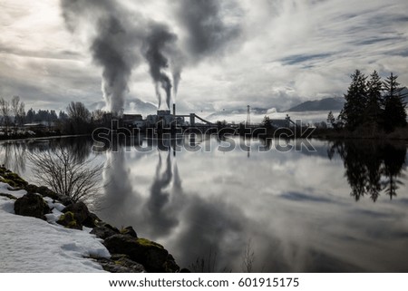 Industrial Plant in front of a river. Picture taken in Port Alberni, Vancouver Island, British Columbia, Canada.