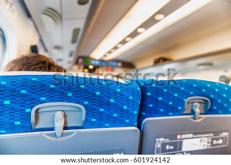 Back view of airplane passengers seats. Royalty-Free Stock Photo #601924142
