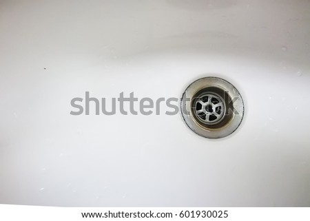 close up dirty sewer drain hole of ceramic hand wash basin with copyspace for text