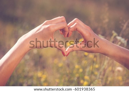 Heart made with woman fingers. Love concept