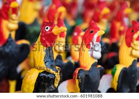 Colorful chicken status as pattern in the temple with word Fortune and Lucky Hen at the base