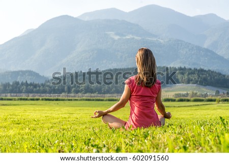 Blonde Woman Doing Yoga at the Mountains