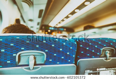 Back view of airplane passengers seats. Royalty-Free Stock Photo #602105372