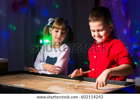Children paint in the sand, sand animation