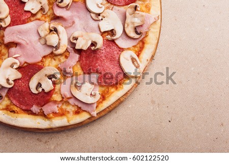 salami pizza with ham and mushrooms in picture corner. Delicious craft pizza