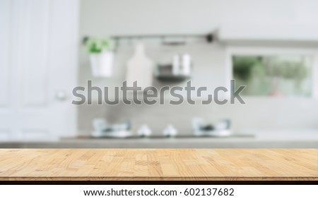 Wood table top on blurred kitchen background, Royalty-Free Stock Photo #602137682