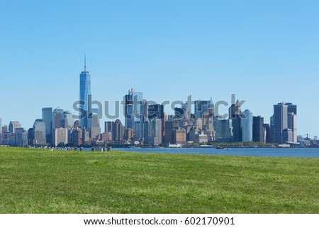 New York city skyline and green meadow, blue sky in a sunny day 