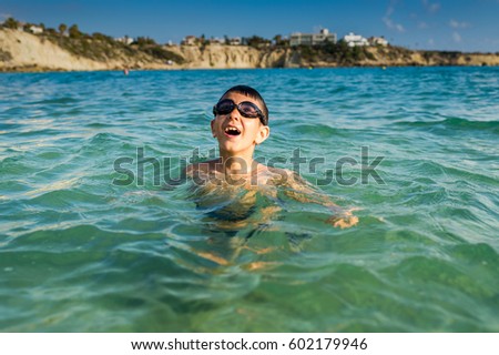 Boy in the sea with diving glasses