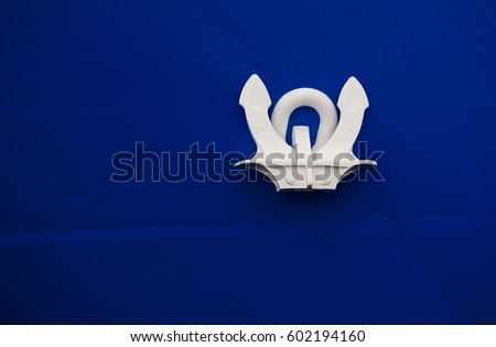 Close Up of stylized anchor of a ship, isolated on a blue background.Genoa.Italy 