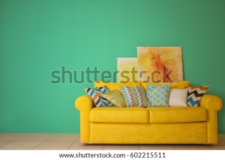 Room interior with sofa on color wall background