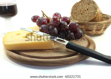 Cheese with fresh grapes, bread and red wine