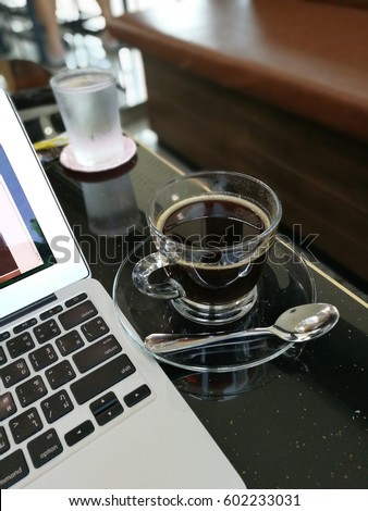 black coffee with. laptop on table