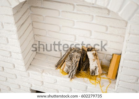 white fireplace with firewood