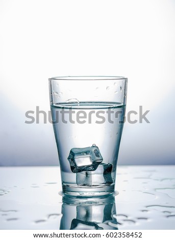 Pieces of ice in a glass with water