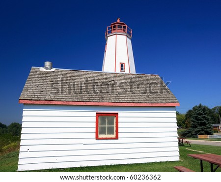 Still picture of Port Burwell Lighting House with service building in front in sunny summer day.