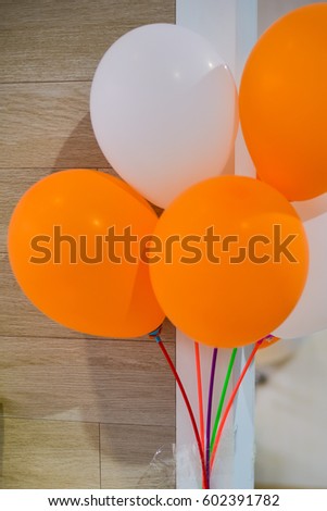 Orange and white balloons decorated in event