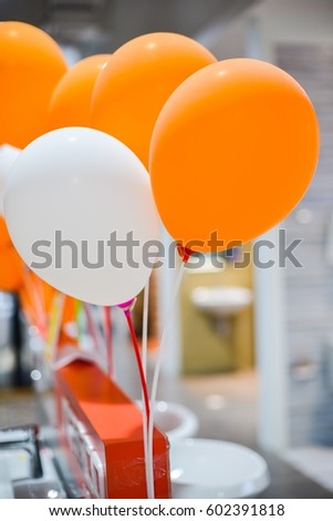 Orange and white balloons decorated in event