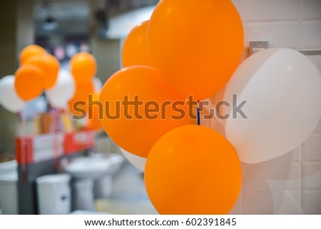 Orange and white balloons decorated in event