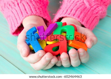 Child learning to read using magnetic letters. Education School  Concept