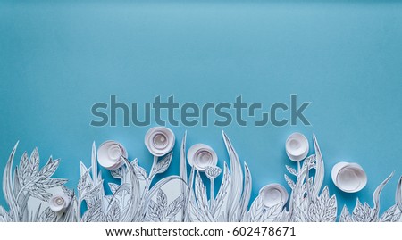 Paper art and origami concept of Flower meadow. White paper flower on blue background. Painted leaves. Copy space