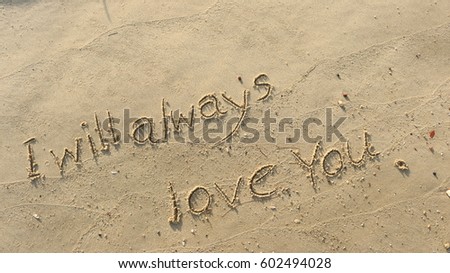 Handwriting words "I will always love you." on sand of beach