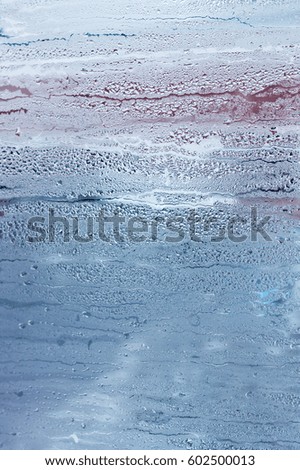 Window glass with condensation, strong, high humidity in the room, large water droplets flow down the , cold tone, natural drops