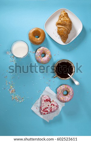 The ideal breakfast for the proper energy for the full day. Fresh coffee with milks and donuts . Hipster pictures. Top view