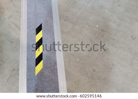 yellow and black stripe warning on the floor