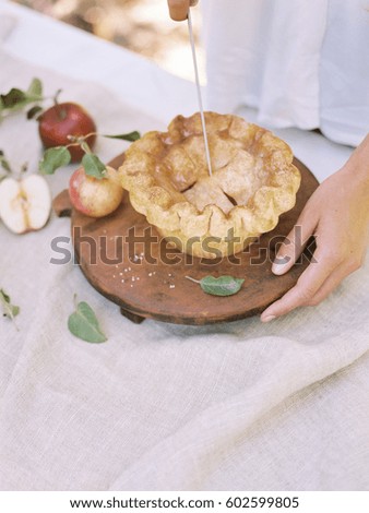 Apple orchard Woman standing at a table with food, an apple pie