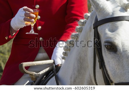 A Master of Foxhounds having a drink at a hunt meet