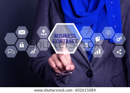 Businesswoman pressing button on virtual screen with word business contract