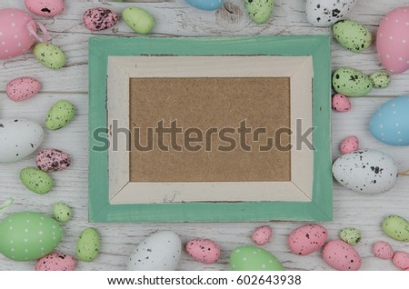 Colored Easter Eggs Over Wooden Background with frame and space for copy, text, words