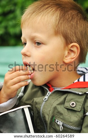 Boy eating popcorn outdoors