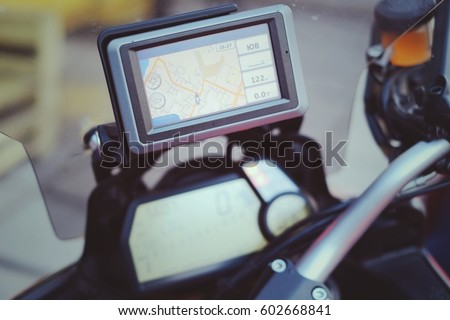 motorcycle travel gps navigation on the handlebars of the red bike. Royalty-Free Stock Photo #602668841