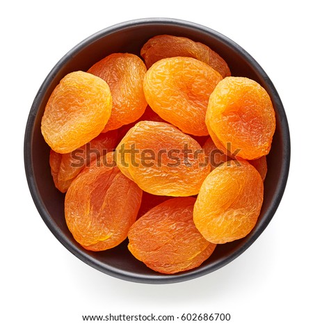 Bowl of dried apricots isolated on white background, top view Royalty-Free Stock Photo #602686700