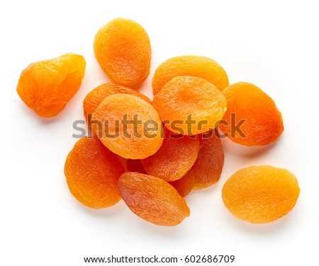 Heap of dried apricots isolated on white background, top view Royalty-Free Stock Photo #602686709