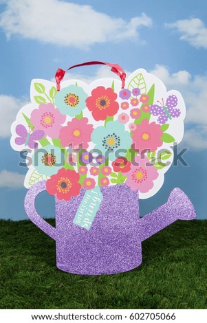 A watering can sign for welcoming spring