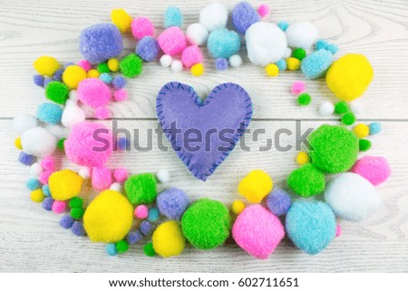 Felt Heart Surrounded by Colorfully Pompons.