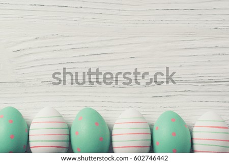 Colorful easter eggs on a wooden background, vintage filter, copy space