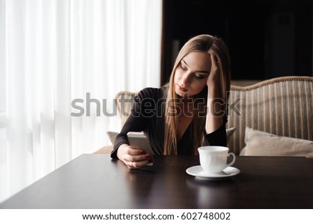 tired business woman working with mobile phone during a break