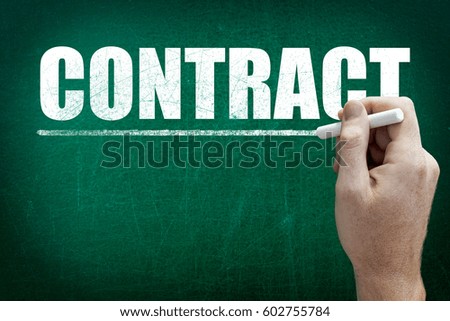 Hand writing the text CONTRACT on the blackboard