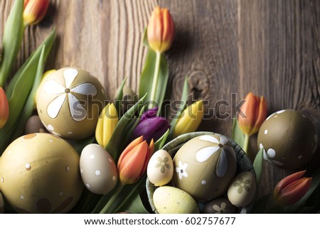 Easter eggs. Colorful bokeh, place for typography and logo. Rustic wooden table. Easter theme.