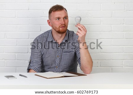 Business or freelance concept. Businessman sitting at the table and working on the computer. It solves important business tasks. He is successful and well-trained. He alone on a white background.