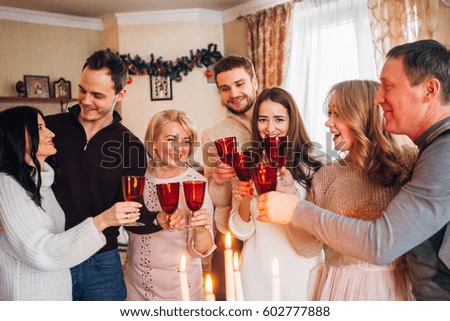 large family celebrates Christmas and drinking champagne