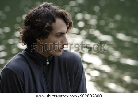 Profile of young man near lake